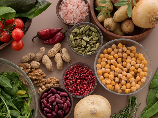 Overhead spread of pulses, nuts and vegetables in small bowls — upscaled by Nano Banana 2