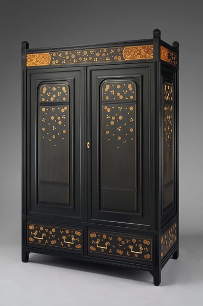 Black lacquered cabinet with gilt floral decoration on a grey studio backdrop — upscaled by Nano Banana 2