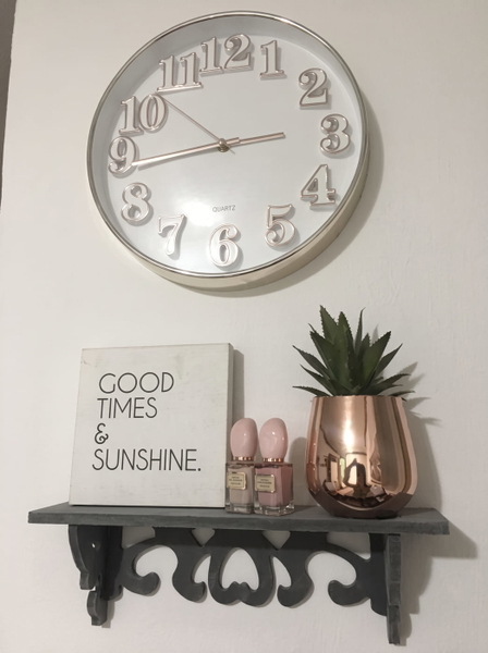 Wall clock above a shelf with a "Good times & sunshine" sign and a succulent — upscaled by GoStudio Advanced