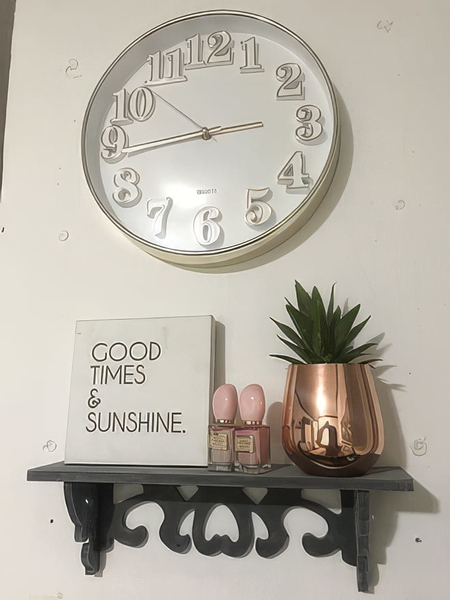 Wall clock above a shelf with a "Good times & sunshine" sign and a succulent — upscaled by GoStudio Pro