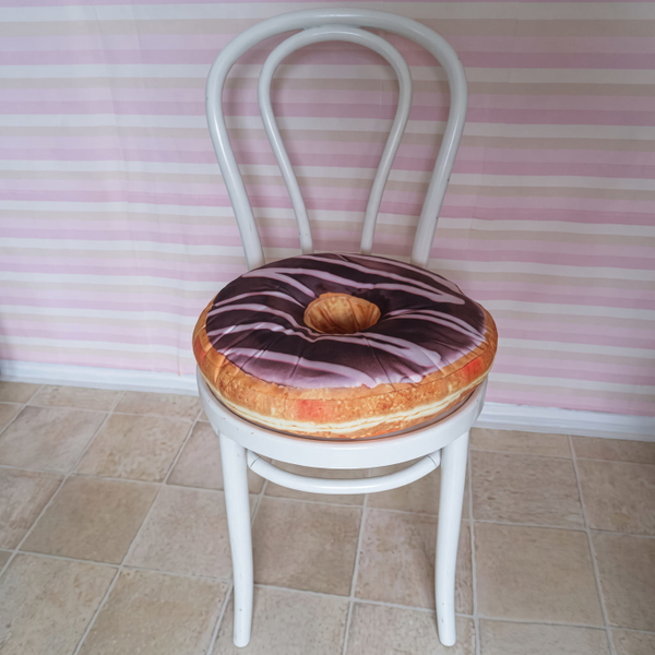 White bentwood chair with a doughnut-shaped cushion against a striped wall — upscaled by GoStudio Advanced