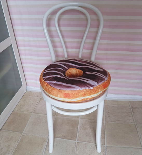 White bentwood chair with a doughnut-shaped cushion against a striped wall — upscaled by Nano Banana 2