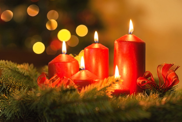 Red candles lit on a pine garland with bokeh lights behind — upscaled by GoStudio Advanced