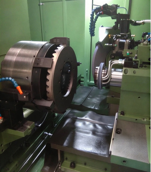 CNC lathe with a chuck and tooling, in a green machine enclosure — upscaled by GoStudio Lite