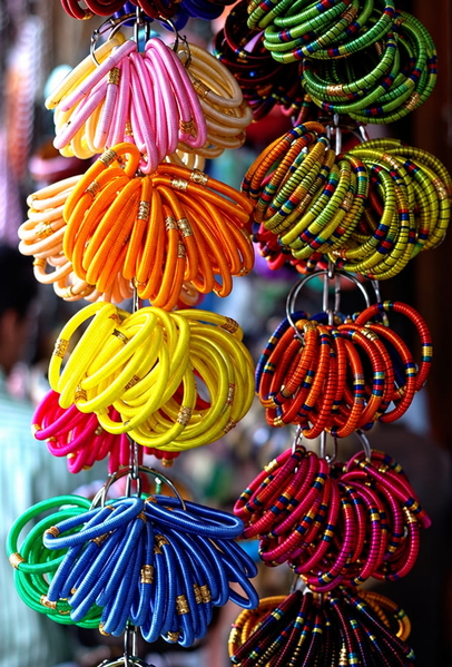 Stacks of coloured bangles hanging at a market stall — upscaled by GPT Image 2.5