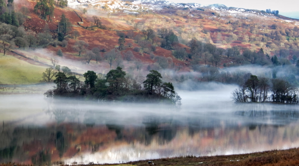 Mist over a lake with autumn hillside behind, at 1920×1080 — upscaled by GoStudio Advanced