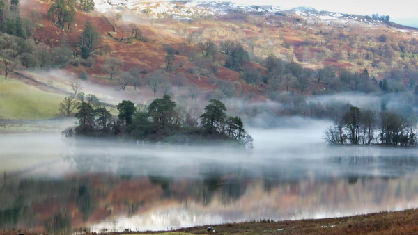 Mist over a lake with autumn hillside behind, at 1920×1080 — upscaled by GoStudio Lite