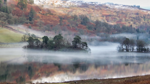 Mist over a lake with autumn hillside behind, at 1920×1080 — upscaled by Nano Banana 2
