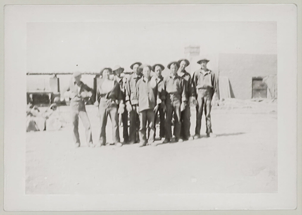 Archive print of a row of men standing outside a building, mounted on card — upscaled by GoStudio Lite