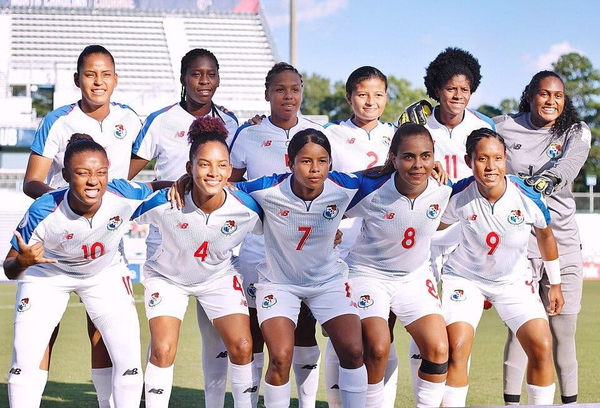 Women’s football team in white kit posing for a team photo in a stadium — watermark removed by GoStudio Lite