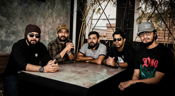 Five men seated around a stone table — watermark removed by GoStudio Advanced