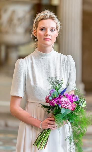 Bride in a white high-necked dress holding a bouquet of roses and lavender — watermark removed by GoStudio Pro