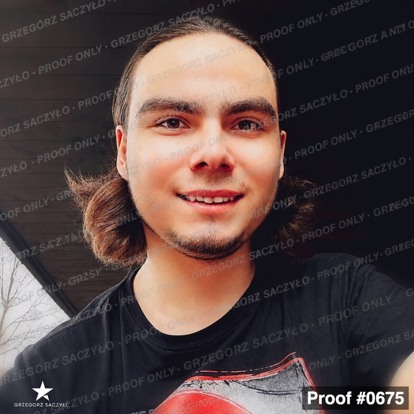 Young man with long hair smiling, in a black T-shirt