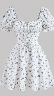 A flat-lay photo of a white dress with blue floral print, puff sleeves, and a v-neckline, laid out for AI virtual try-on.