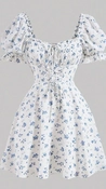 A flat-lay photo of a white dress with blue floral print, puff sleeves, and a v-neckline, laid out for AI virtual try-on. A flat-lay photo of a white dress with blue floral print, puff sleeves, and a v-neckline, laid out for AI virtual try-on.