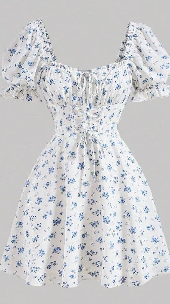 A flat-lay photo of a white dress with blue floral print, puff sleeves, and a v-neckline, laid out for AI virtual try-on. A flat-lay photo of a white dress with blue floral print, puff sleeves, and a v-neckline, laid out for AI virtual try-on.