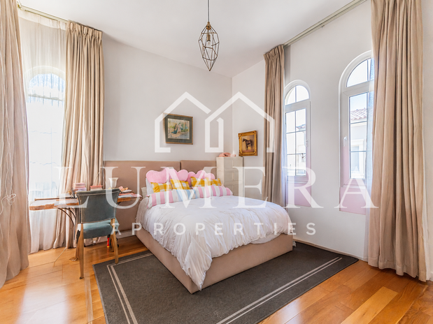 A furnished bedroom photo shown with a watermark across it