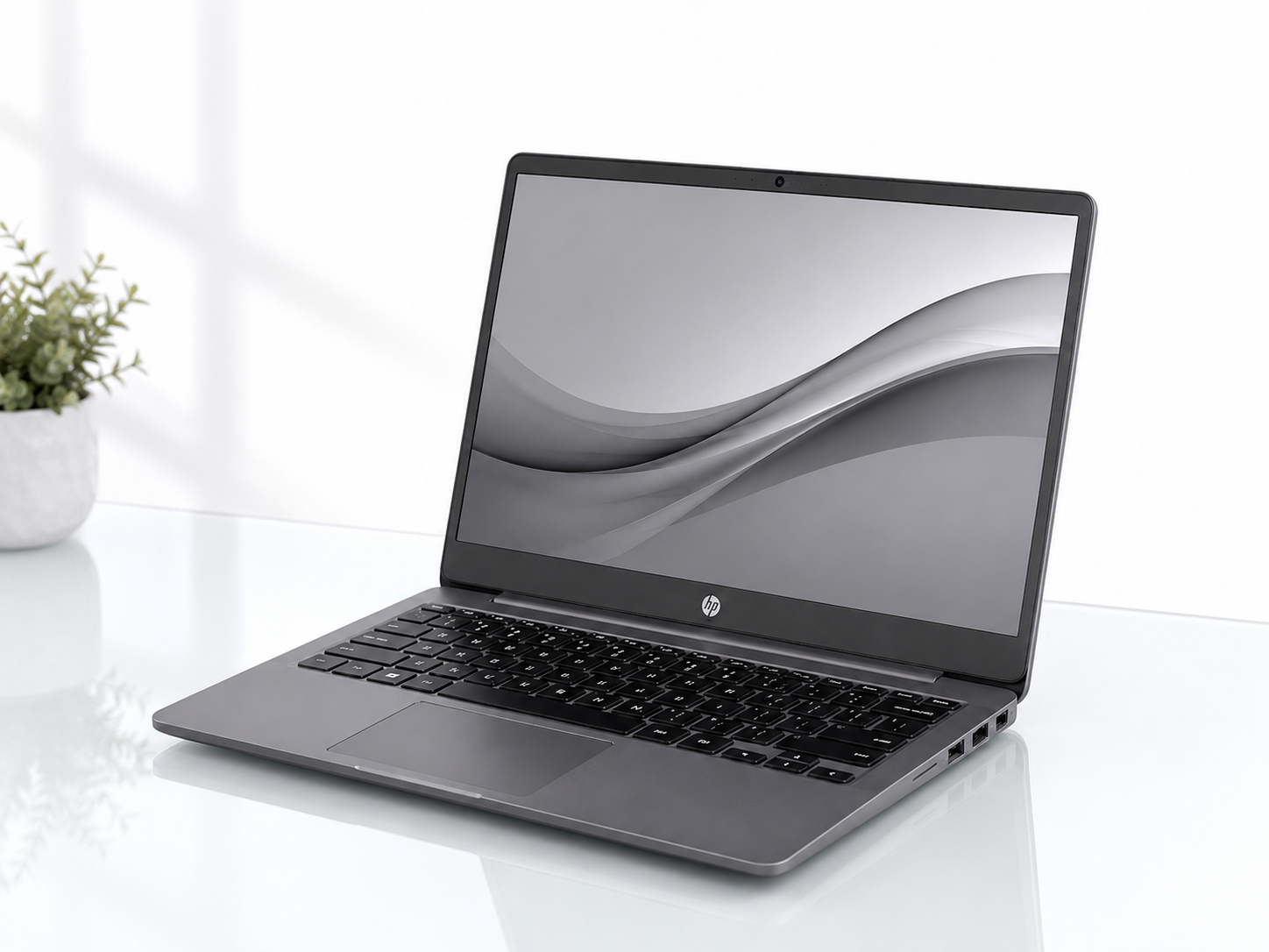 The image shows a HP Elitebook Folio 1040 G3 laptop computer sitting on top of a white table next to a potted plant. The laptop has a sleek, modern design with a black finish and a silver HP logo on the lid. The plant is a vibrant green, adding a touch of nature to the scene. The image shows a HP Elitebook Folio 1040 G3 laptop computer sitting on top of a white table next to a potted plant. The laptop has a sleek, modern design with a black finish and a silver HP logo on the lid. The plant is a vibrant green, adding a touch of nature to the scene.