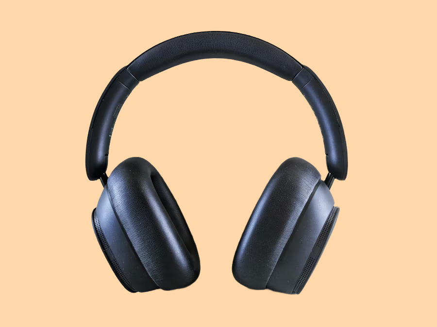 Black over-ear headphones on a peach background after AI background removal