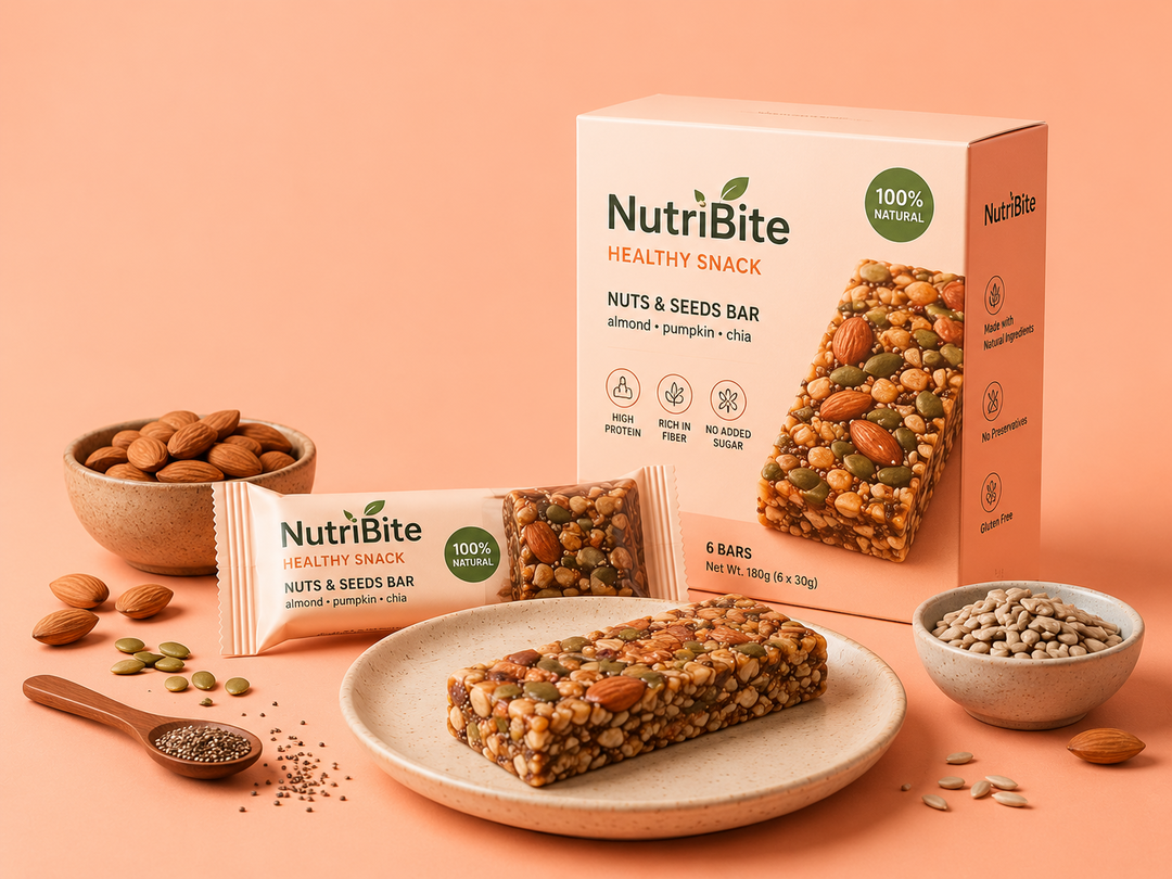 The image shows a plate with a nutribite healthy snack bar on it, surrounded by bowls of nuts and seeds. There is also a spoon on the plate, suggesting that the snack bar is ready to be enjoyed.