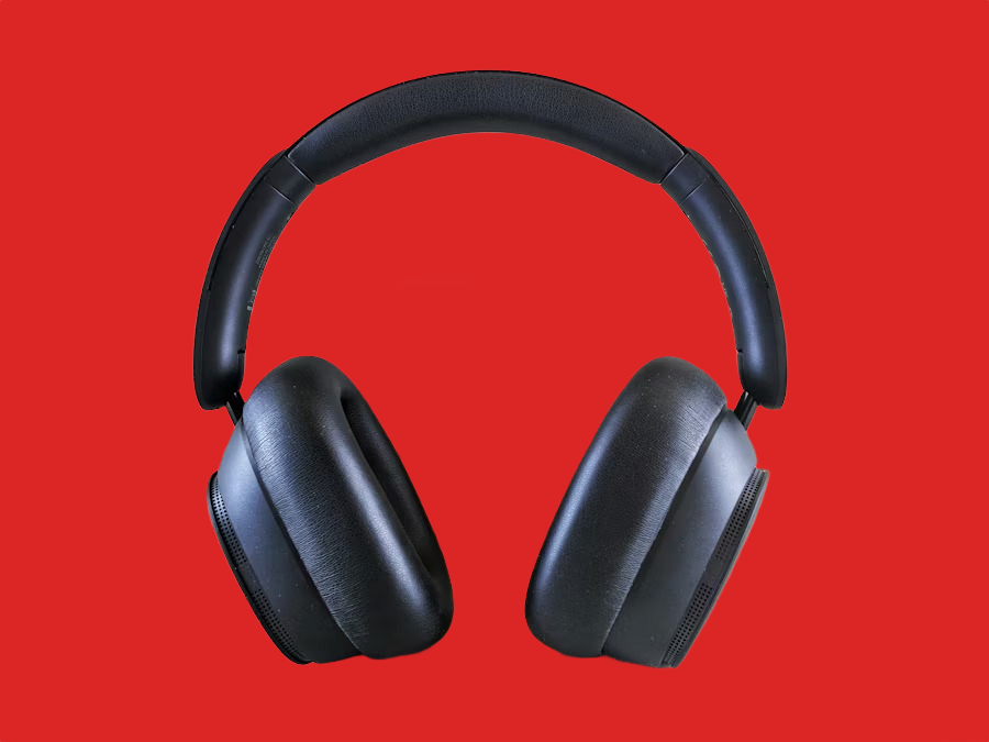 Black over-ear headphones on a red background after AI background removal