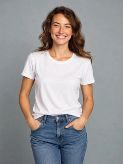 A woman in a plain white t-shirt and jeans against a grey studio wall, before the AI clothes changer swaps the outfit