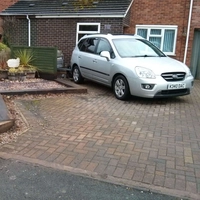 Sample photo of a silver car parked on a block-paved driveway to try in the AI image replacer