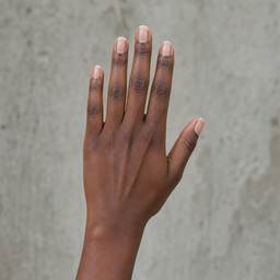 A hand with deep skin tone and natural nails held open in daylight, a sample photo for the nail color changer.