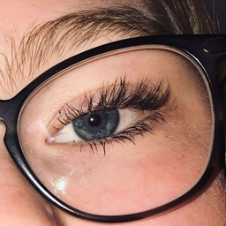 A man in black glasses with brown eyes, a sample photo for the eye color changer