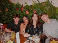 Sample photo of four friends at a restaurant table, to try removing a person from a group photo